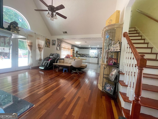 living room featuring high vaulted ceiling, ceiling fan, dark wood-style floors, and visible vents
