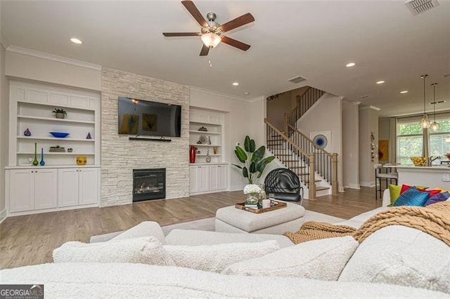 820 Fair View Cir, Roswell, GA 30076 - living room with ceiling fan, crown molding, light wood finished floors, and visible vents