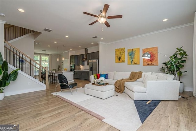 820 Fair View Cir, Roswell, GA 30076 - living area featuring visible vents, light wood-style floors, a ceiling fan, stairs, and crown molding