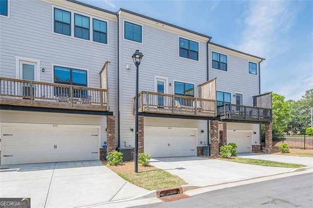 820 Fair View Cir, Roswell, GA 30076 - exterior space featuring an attached garage, central AC unit, concrete driveway, and fence