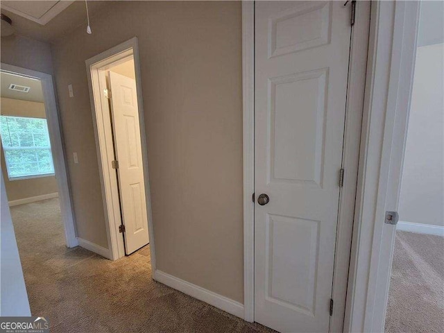 115 Heather Ln, Commerce, GA 30529 - hallway with light colored carpet, baseboards, attic access, and visible vents
