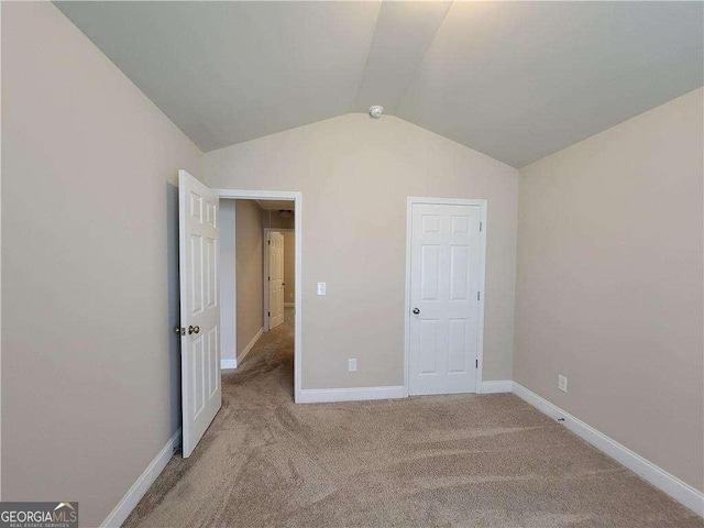 115 Heather Ln, Commerce, GA 30529 - unfurnished bedroom featuring lofted ceiling, baseboards, and carpet floors