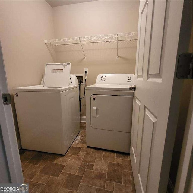 115 Heather Ln, Commerce, GA 30529 - washroom featuring stone finish flooring, laundry area, and independent washer and dryer