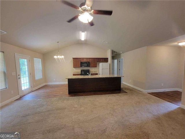 115 Heather Ln, Commerce, GA 30529 - kitchen with carpet, lofted ceiling, light countertops, black appliances, and open floor plan