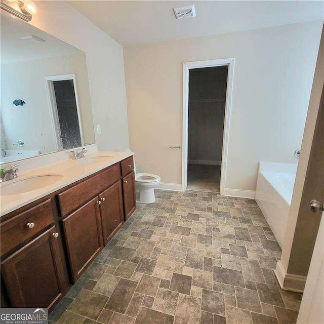 115 Heather Ln, Commerce, GA 30529 - full bathroom featuring visible vents, toilet, baseboards, and a sink