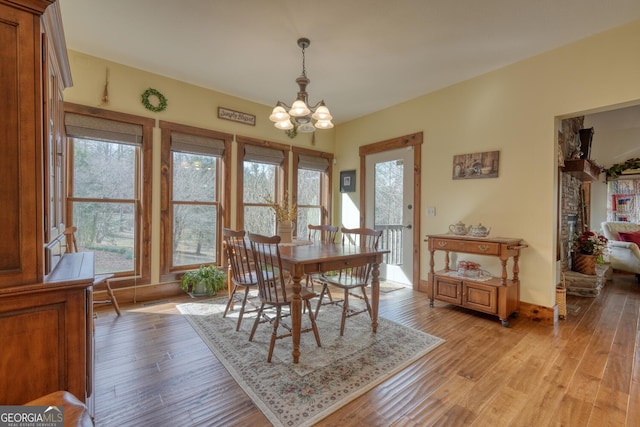 dining space with a chandelier and light wood-style floors
