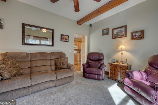 living room with beamed ceiling, baseboards, carpet floors, and ceiling fan