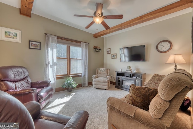 carpeted living room with ceiling fan, baseboards, and beam ceiling