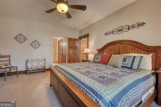 bedroom featuring light carpet, a ceiling fan, and baseboards