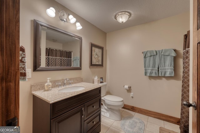 full bathroom with vanity, toilet, tile patterned flooring, and baseboards