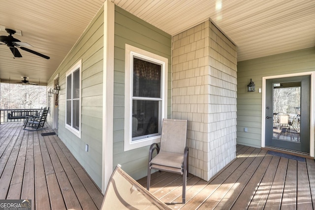 deck with a porch and a ceiling fan