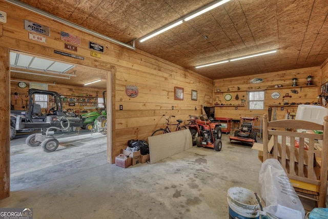 garage featuring wood walls and a workshop area