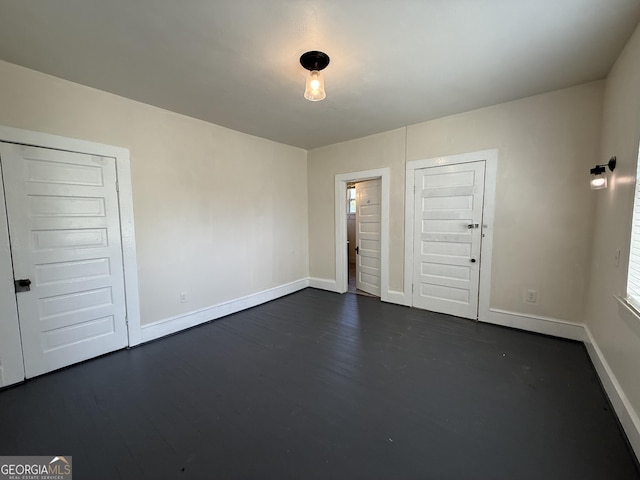 30 Poplar St, Porterdale, GA 30014 - empty room featuring dark wood finished floors and baseboards