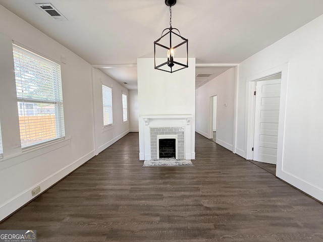 30 Poplar St, Porterdale, GA 30014 - unfurnished living room featuring dark wood-type flooring, visible vents, baseboards, and a fireplace