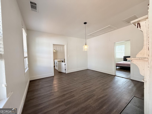 30 Poplar St, Porterdale, GA 30014 - unfurnished dining area with attic access, visible vents, baseboards, and dark wood-style flooring