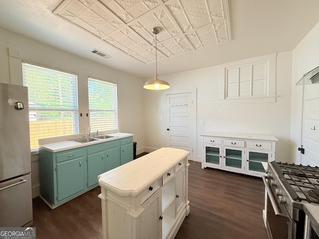 30 Poplar St, Porterdale, GA 30014 - kitchen featuring green cabinetry, appliances with stainless steel finishes, a sink, and dark wood-style flooring