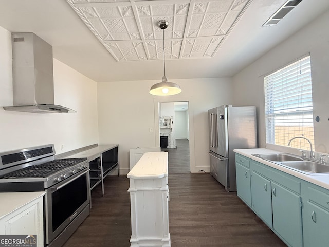 30 Poplar St, Porterdale, GA 30014 - kitchen featuring a sink, wall chimney exhaust hood, appliances with stainless steel finishes, dark wood-type flooring, and visible vents