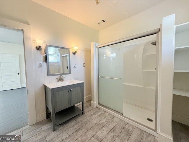 30 Poplar St, Porterdale, GA 30014 - full bath featuring a shower stall, visible vents, vanity, and wood finished floors