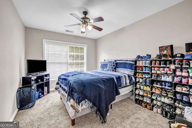 carpeted bedroom with a ceiling fan and baseboards