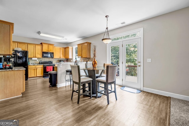 dining space with wood finished floors and baseboards