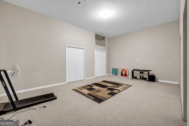 exercise area with carpet flooring and baseboards