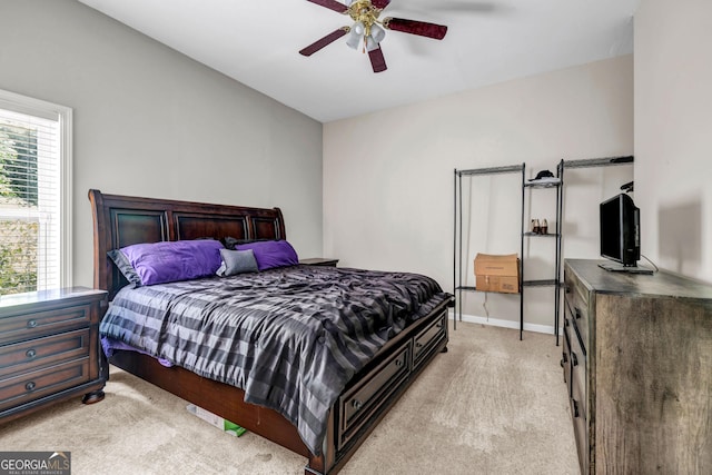 bedroom with light carpet, baseboards, and ceiling fan