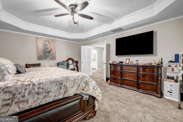 bedroom with a raised ceiling, carpet flooring, ornamental molding, and a ceiling fan