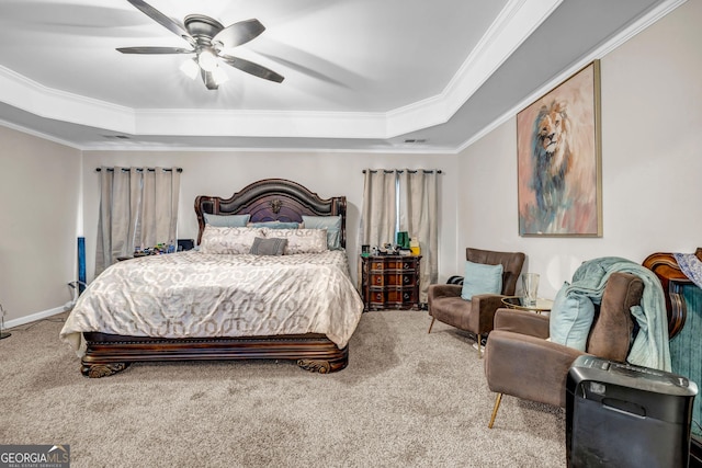 bedroom featuring a tray ceiling, carpet floors, crown molding, and ceiling fan