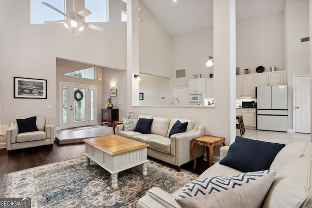 547 E Cardinal Cir, Saint Marys, GA 31558 - living area with baseboards, light wood-style floors, visible vents, ceiling fan, and high vaulted ceiling