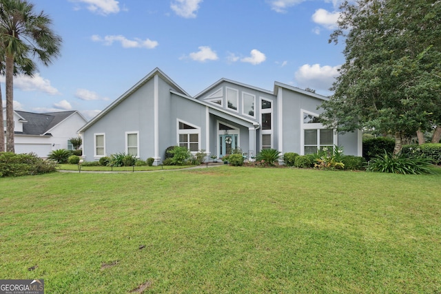 547 E Cardinal Cir, Saint Marys, GA 31558 - view of front of house with a front lawn and stucco siding
