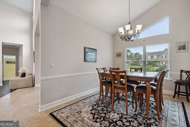 547 E Cardinal Cir, Saint Marys, GA 31558 - dining space with tile patterned flooring, baseboards, high vaulted ceiling, and an inviting chandelier