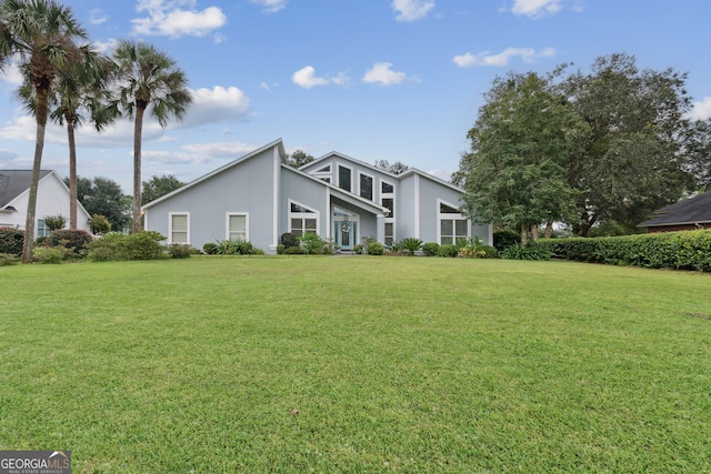 547 E Cardinal Cir, Saint Marys, GA 31558 - view of front of house featuring stucco siding and a front lawn
