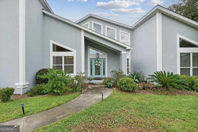 547 E Cardinal Cir, Saint Marys, GA 31558 - entrance to property with stucco siding and a lawn