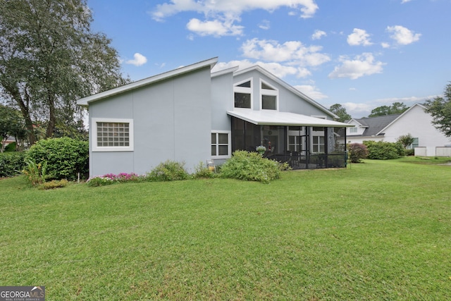547 E Cardinal Cir, Saint Marys, GA 31558 - back of property featuring a yard, stucco siding, and a sunroom