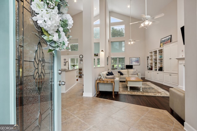 547 E Cardinal Cir, Saint Marys, GA 31558 - tiled living area with high vaulted ceiling, baseboards, and ceiling fan