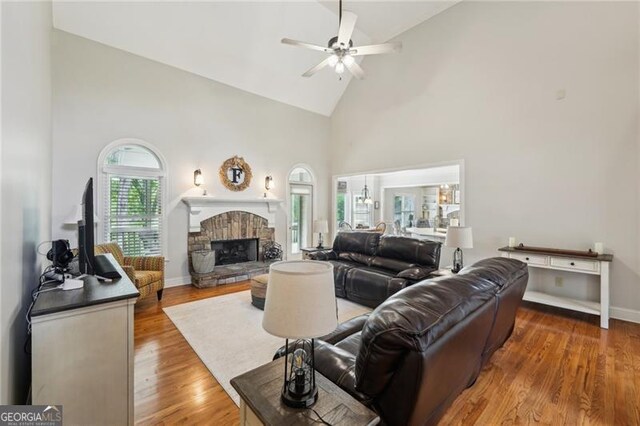 6565 Scottsfield Trce, Cumming, GA 30028 - living area featuring high vaulted ceiling, wood finished floors, ceiling fan, a fireplace, and baseboards