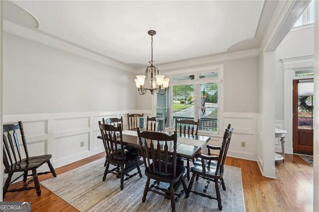 6565 Scottsfield Trce, Cumming, GA 30028 - dining room featuring a decorative wall, a notable chandelier, wood finished floors, and plenty of natural light