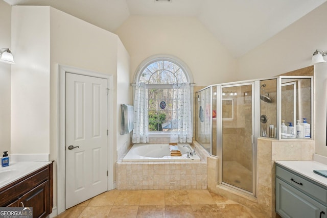 bathroom with a shower stall, lofted ceiling, tile patterned floors, vanity, and a garden tub