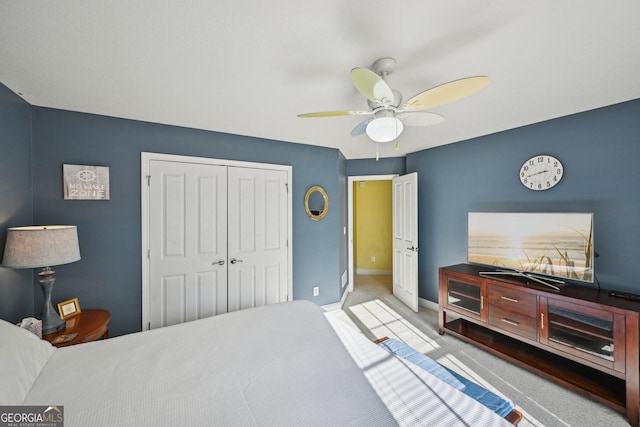 carpeted bedroom with a closet, a ceiling fan, and baseboards