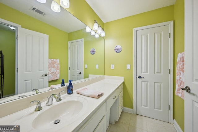 bathroom featuring baseboards, visible vents, tile patterned flooring, and vanity
