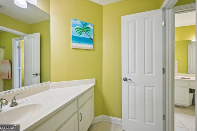 bathroom with baseboards, vanity, tile patterned floors, and visible vents