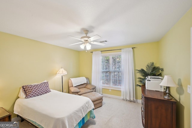 bedroom featuring baseboards, a ceiling fan, visible vents, and light colored carpet