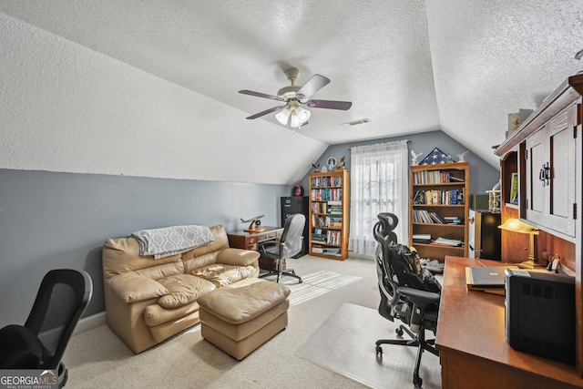 office space featuring vaulted ceiling, a textured ceiling, carpet, and visible vents