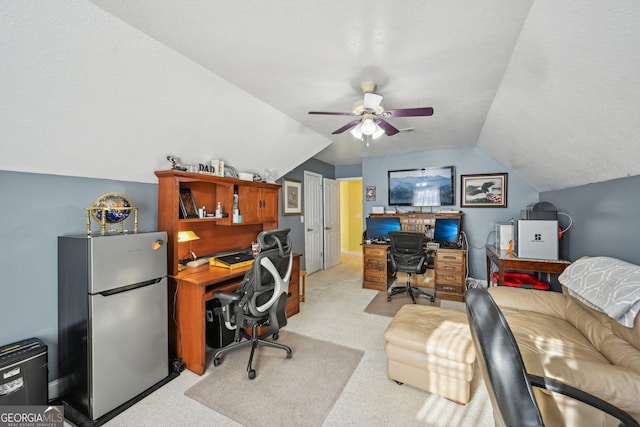 office space with vaulted ceiling, light colored carpet, and ceiling fan
