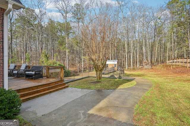 view of yard with fence and a deck