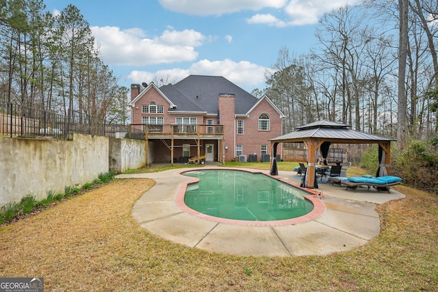 outdoor pool featuring fence, a patio area, a gazebo, and a yard