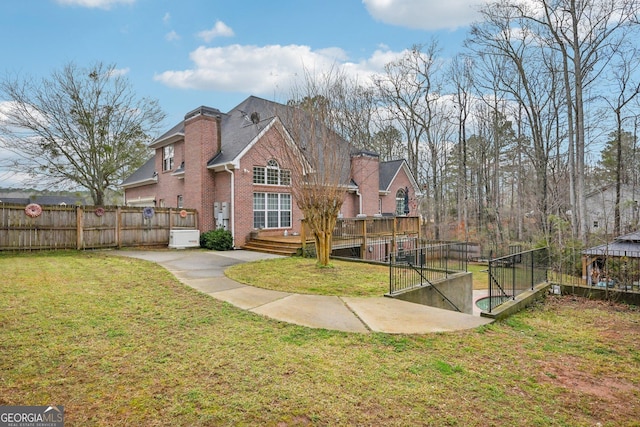 exterior space with fence, a lawn, a gazebo, and a wooden deck