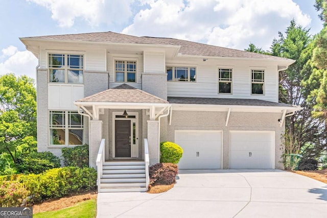 2675 Sugar Mill Dr, Atlanta, GA 30316 - view of front facade with a garage, driveway, roof with shingles, and brick siding