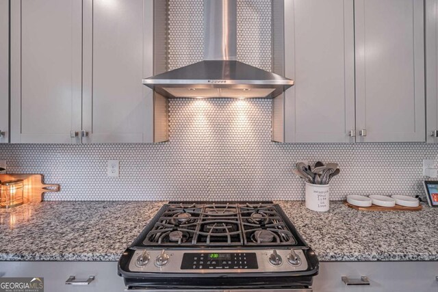 2675 Sugar Mill Dr, Atlanta, GA 30316 - kitchen with wall chimney range hood, light stone counters, tasteful backsplash, and gas range