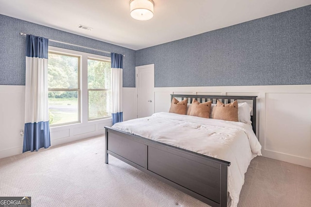 2675 Sugar Mill Dr, Atlanta, GA 30316 - bedroom with visible vents, carpet, and a wainscoted wall